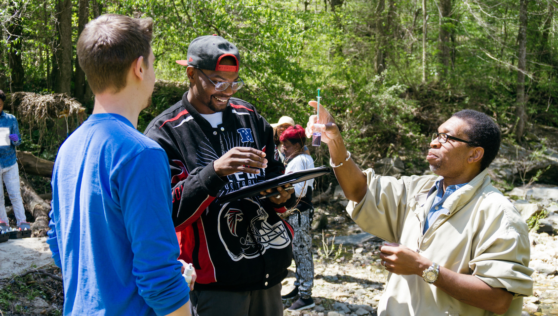 Group of people gathering data from the river